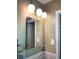 Medicine cabinet with chrome lighting fixtures, tile wall and matching towel rack at 4179 Westview St, Douglasville, GA 30135