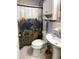 Full bathroom with a toilet and a sink adjacent to a bear Gathering patterned shower curtain at 4179 Westview St, Douglasville, GA 30135
