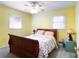 Bright bedroom with yellow walls, ceiling fan, and a window view at 4179 Westview St, Douglasville, GA 30135
