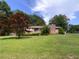 Quaint single-story brick home with a neatly maintained lawn and mature landscaping at 4179 Westview St, Douglasville, GA 30135