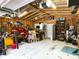 Spacious garage interior with exposed beams, workbenches, equipment and overhead storage creating an organized workspace at 4179 Westview St, Douglasville, GA 30135