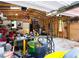 Spacious garage interior with exposed beams, workbenches, equipment and overhead storage creating an organized workspace at 4179 Westview St, Douglasville, GA 30135