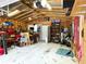 Spacious garage interior with exposed beams, workbenches, equipment and overhead storage creating an organized workspace at 4179 Westview St, Douglasville, GA 30135