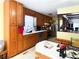 Kitchen area featuring wooden cabinets, white countertops, and modern appliances, with a breakfast bar at 4179 Westview St, Douglasville, GA 30135