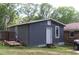 A storage building exterior, providing additional storage with a trailer, set amongst a lush backyard landscape at 4179 Westview St, Douglasville, GA 30135