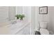 Powder room with modern vanity, quartz countertop, and decorative plant at 456 Parkway Ne Dr # 10, Atlanta, GA 30308