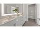 Well-lit bathroom with double vanity, quartz countertop, and tiled floors at 456 Parkway Ne Dr # 10, Atlanta, GA 30308