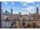 Beautiful city skyline view from private balcony overlooking lush green trees at 456 Parkway Ne Dr # 10, Atlanta, GA 30308