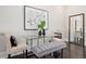 Dining area featuring a glass table, upholstered chairs, a plush bench and decorative art at 456 Parkway Ne Dr # 10, Atlanta, GA 30308