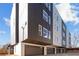 Modern townhome exterior with sleek design, garage doors, and large windows at 456 Parkway Ne Dr # 10, Atlanta, GA 30308