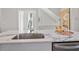 Kitchen island boasts marble countertop with stainless steel sink and modern faucet at 456 Parkway Ne Dr # 10, Atlanta, GA 30308