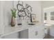 Elegant wet bar with marble countertop, white cabinetry, and stylish decor at 456 Parkway Ne Dr # 10, Atlanta, GA 30308