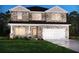 Charming two-story home featuring a stone facade and a spacious two-car garage at 6920 Chester St, Fairburn, GA 30213