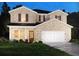 Two-story home featuring a brick facade, a two-car garage, and a well-manicured lawn at 6921 Chester St, Fairburn, GA 30213