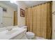 Simple bathroom featuring a large vanity, toilet, and shower with beige shower curtain at 1360 Woodvine Way, Alpharetta, GA 30005