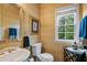 Classic half bath with decorative mirror and window at 1360 Woodvine Way, Alpharetta, GA 30005