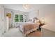 Bedroom features large windows, ceiling fan, and neutral walls at 1360 Woodvine Way, Alpharetta, GA 30005