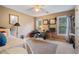 Bedroom features large windows, ceiling fan, beige carpet, and neutral walls at 1360 Woodvine Way, Alpharetta, GA 30005