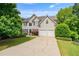 Attractive two-story home with a long driveway, attached two car garage, and mature landscaping at 1360 Woodvine Way, Alpharetta, GA 30005
