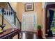 Lovely foyer with beautiful staircase, hardwood floors, and front door at 1360 Woodvine Way, Alpharetta, GA 30005