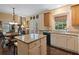 Open kitchen featuring an island with seating, granite counters, and a dining area at 1360 Woodvine Way, Alpharetta, GA 30005