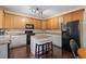 Well-lit kitchen with granite countertops, island seating, and modern black appliances at 1360 Woodvine Way, Alpharetta, GA 30005