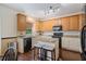 Bright kitchen featuring an island with seating, granite counters, and ample cabinet space at 1360 Woodvine Way, Alpharetta, GA 30005