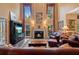 Elegant living room with high ceilings, large windows, and a cozy fireplace at 1360 Woodvine Way, Alpharetta, GA 30005