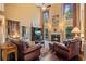 Cozy living room featuring a fireplace, high ceilings, and plenty of natural light at 1360 Woodvine Way, Alpharetta, GA 30005