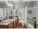 Bathroom with double vanity, tub/shower, and natural light from the window at 200 Valley Xing, Canton, GA 30114