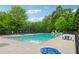Spacious community pool surrounded by trees and lounge furniture for residents to enjoy outdoor leisure at 200 Valley Xing, Canton, GA 30114