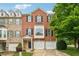 Charming brick townhome featuring a two-car garage and well-maintained landscaping at 200 Valley Xing, Canton, GA 30114