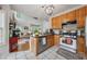 Open kitchen features wooden cabinets, stainless steel appliances, tile backsplash, and granite countertops at 200 Valley Xing, Canton, GA 30114