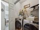 Convenient laundry room with modern washer and dryer units and storage shelves at 200 Valley Xing, Canton, GA 30114