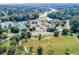 Aerial view of the community with lake, tennis courts, pool, clubhouse, and playgrounds at 2118 Town Manor Ct, Dacula, GA 30019