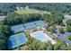 Bird's eye view of the pool, tennis courts, and green space of a golf and tennis community at 2118 Town Manor Ct, Dacula, GA 30019
