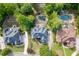 A high-definition shot of three beautiful suburban homes with carefully manicured lawns and pristine landscaping at 2118 Town Manor Ct, Dacula, GA 30019