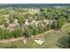 Gorgeous aerial view of home on golf course, surrounded by mature trees and lush landscaping at 2118 Town Manor Ct, Dacula, GA 30019