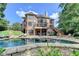 Stunning backyard with in-ground pool, brick patio, fire pit and the home's exterior at 2118 Town Manor Ct, Dacula, GA 30019