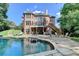 Expansive backyard featuring a brick house, in-ground pool, fire pit, and outdoor dining at 2118 Town Manor Ct, Dacula, GA 30019