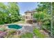 This brick home features a private backyard pool, a stone patio, and is beautifully landscaped for outdoor relaxation at 2118 Town Manor Ct, Dacula, GA 30019