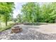 Backyard pool area with a stone fire pit and landscaped surroundings, creating a perfect space for outdoor gatherings at 2118 Town Manor Ct, Dacula, GA 30019
