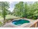 Backyard with pool, hot tub, and landscaped surroundings, offering a relaxing and luxurious outdoor living space at 2118 Town Manor Ct, Dacula, GA 30019