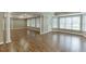Finished basement with multiple windows, hardwood flooring, and painted in neutral colors at 2118 Town Manor Ct, Dacula, GA 30019