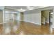 Large finished basement with hardwood flooring, neutral paint, and support columns at 2118 Town Manor Ct, Dacula, GA 30019