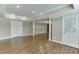 Large finished basement with hardwood floors, recessed lights, and white support columns at 2118 Town Manor Ct, Dacula, GA 30019