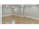 Spacious basement area features hardwood floors, crown molding, and recessed lighting, ideal for flexible living and entertaining at 2118 Town Manor Ct, Dacula, GA 30019
