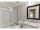 Bathroom with shower-tub combo, marble countertop vanity, and a stylish mirror, offering a clean and functional space at 2118 Town Manor Ct, Dacula, GA 30019