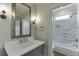 Elegant bathroom features a vanity with marble countertop, a large mirror, and tiled shower at 2118 Town Manor Ct, Dacula, GA 30019