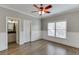 Bright bedroom with hardwood floors, large window, ceiling fan, and attached bathroom at 2118 Town Manor Ct, Dacula, GA 30019